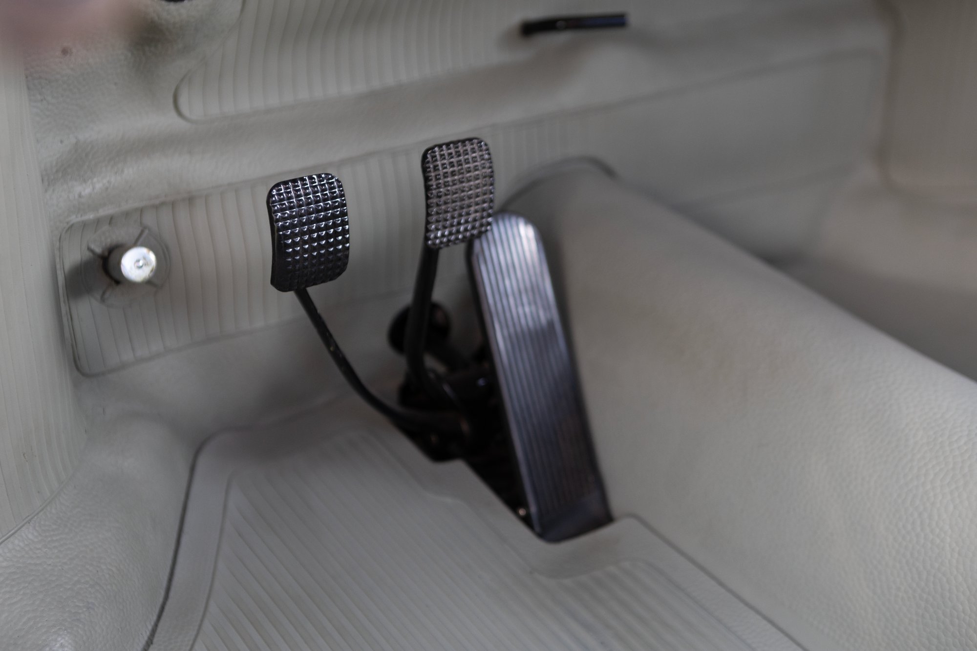 Restored pedal assembly surrounded by rubber flooring by Lowlight Werks in New Hampshire.